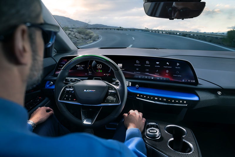 Front View of the 2026 OPTIQ-V Driving Through the Dusk Utilizing its Headlights | Dan Vaden Cadillac Savannah in Savannah GA